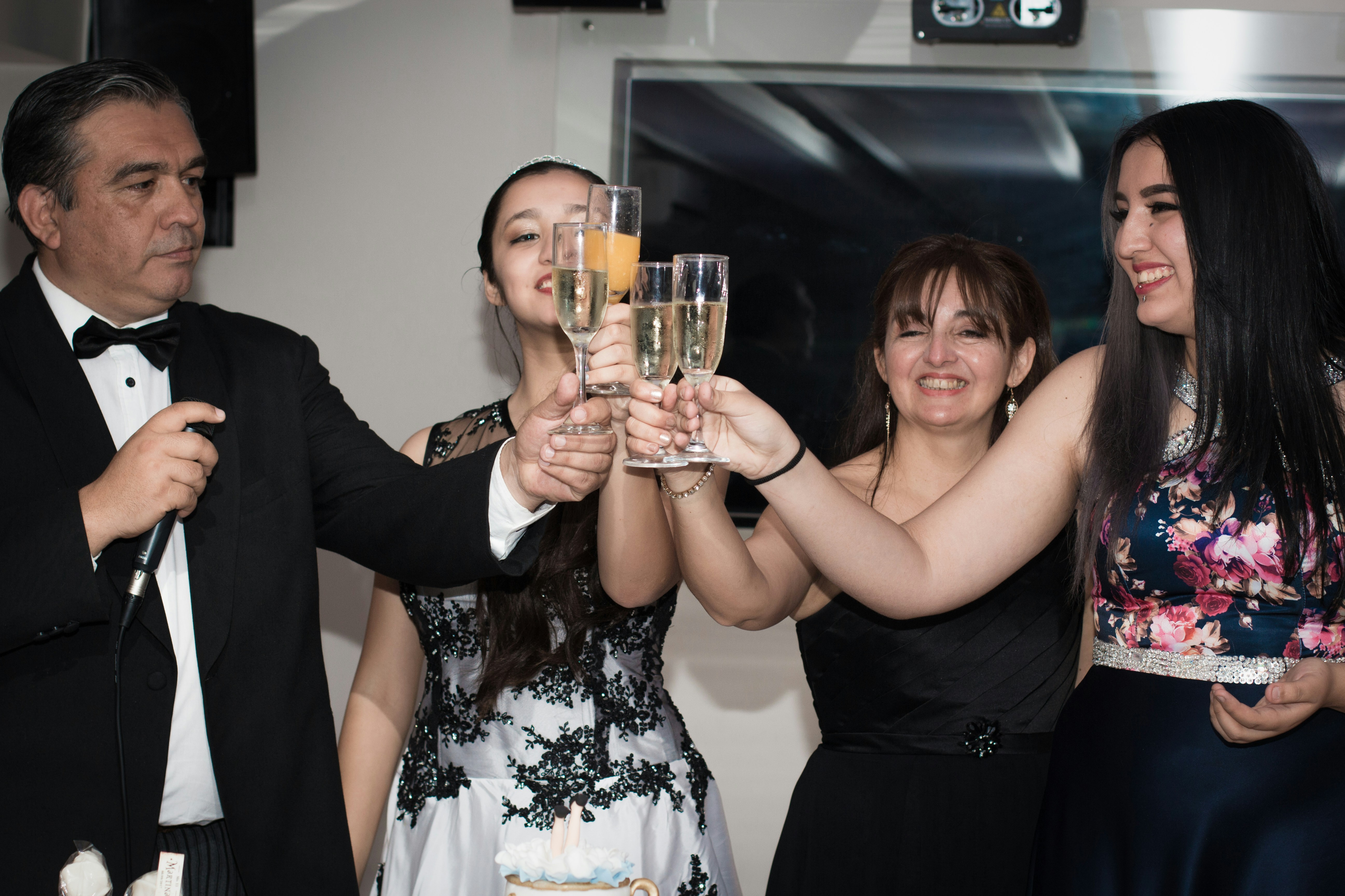 Party guests raising champagne glasses in celebration toast