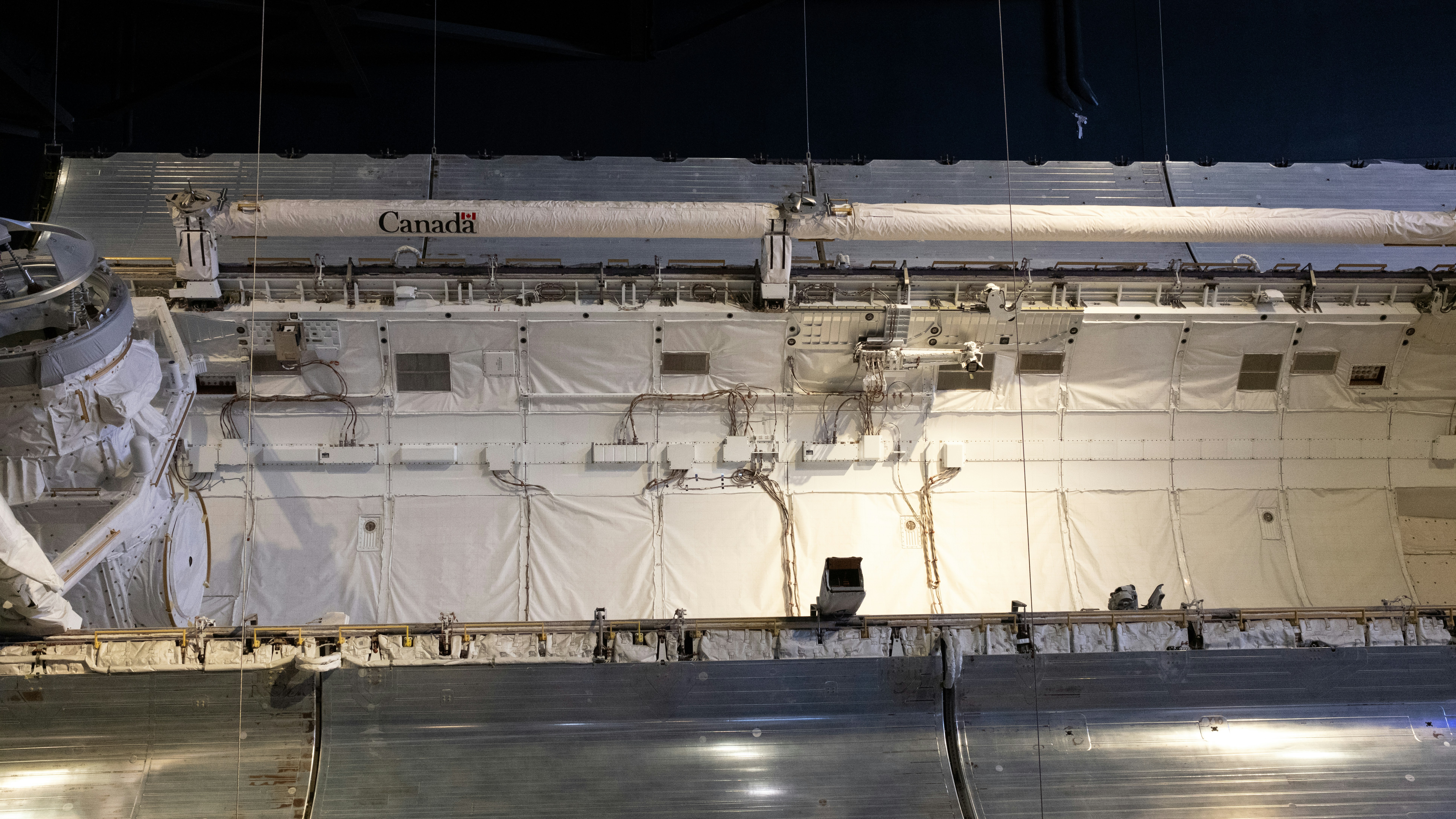 A large space ship with a lot of lights on it's side