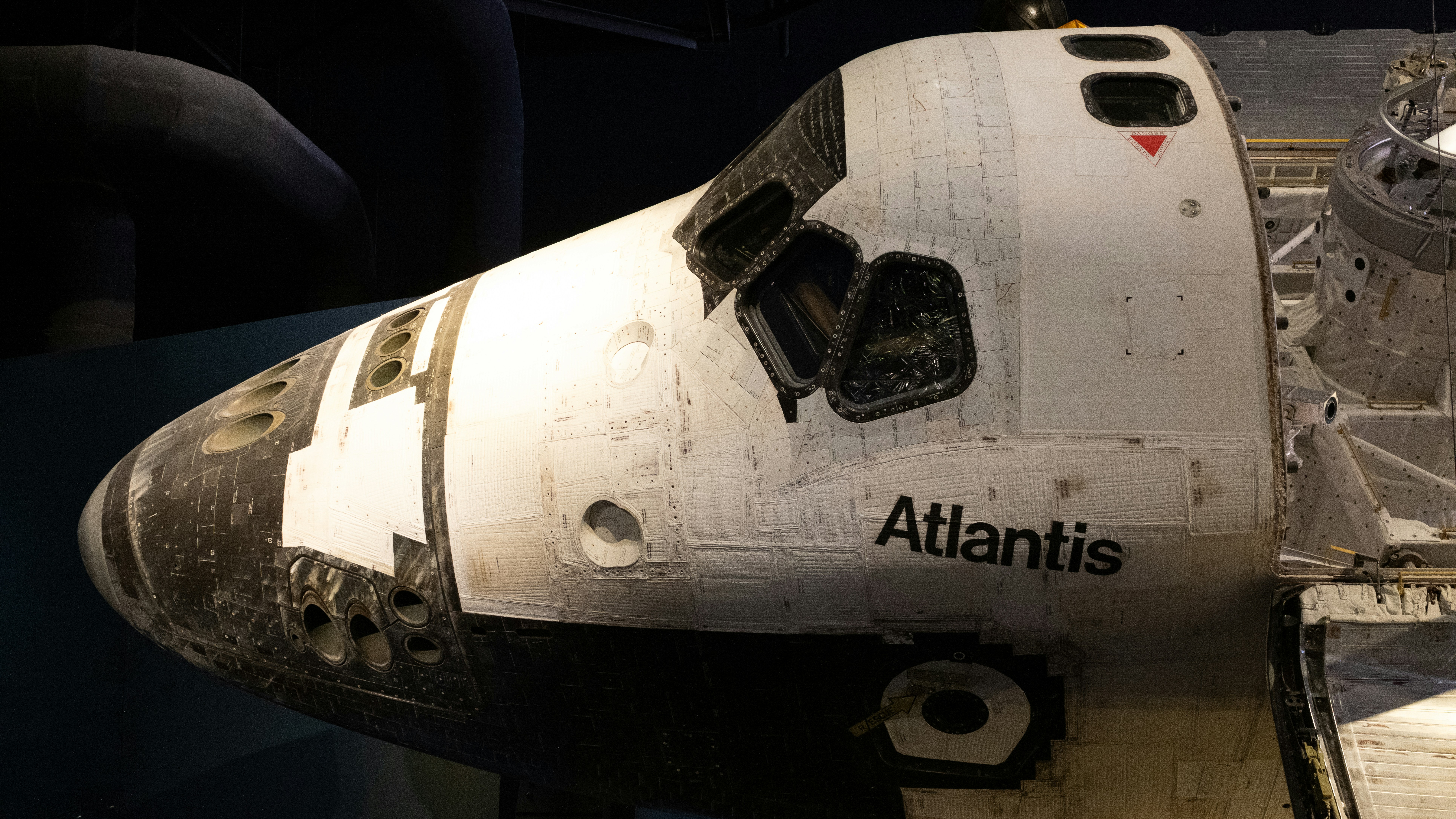 A space shuttle sitting on top of a wooden floor