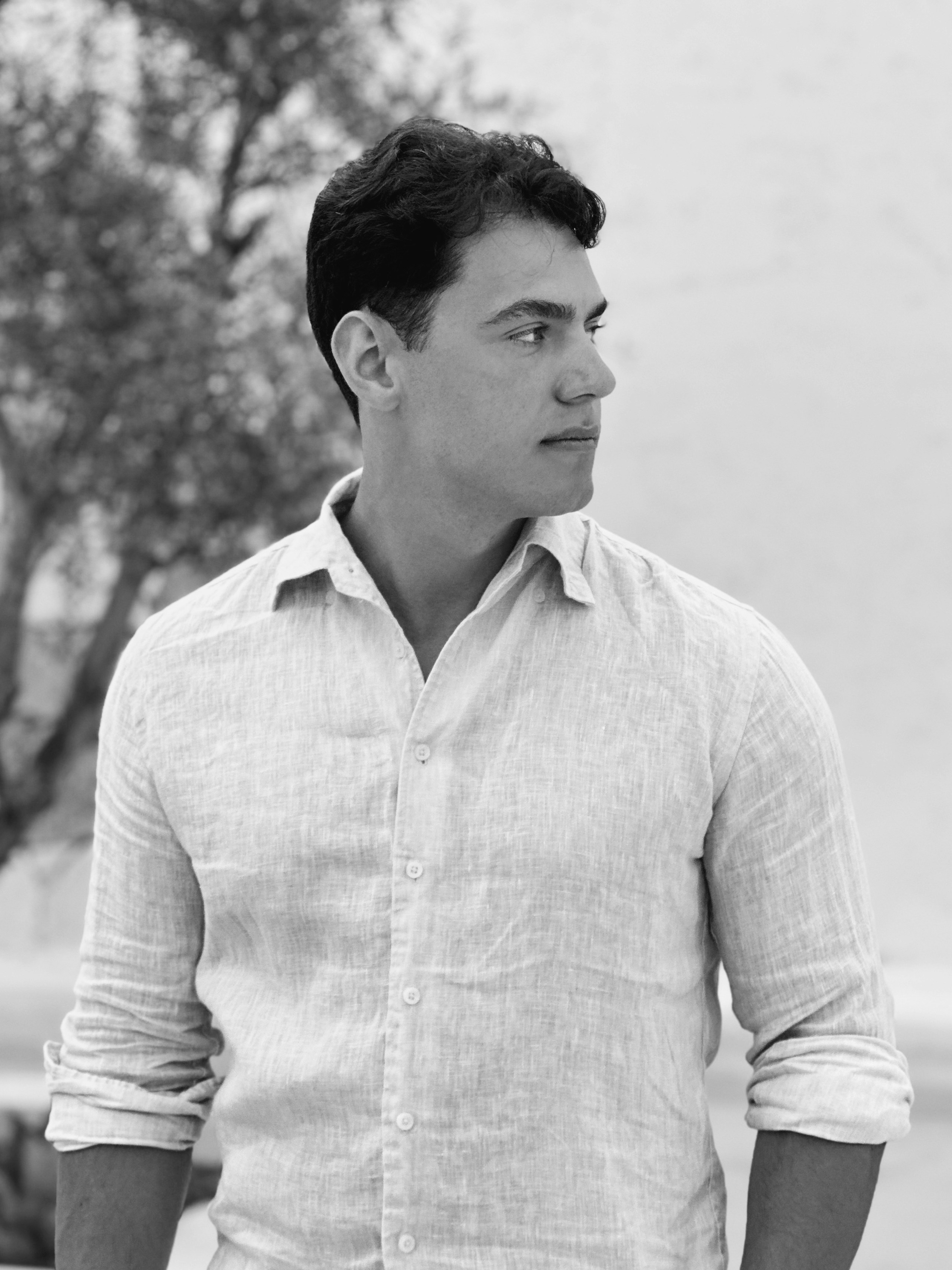 A black and white photo of a man in a white shirt