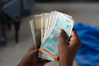 A person holding a bunch of money in their hand