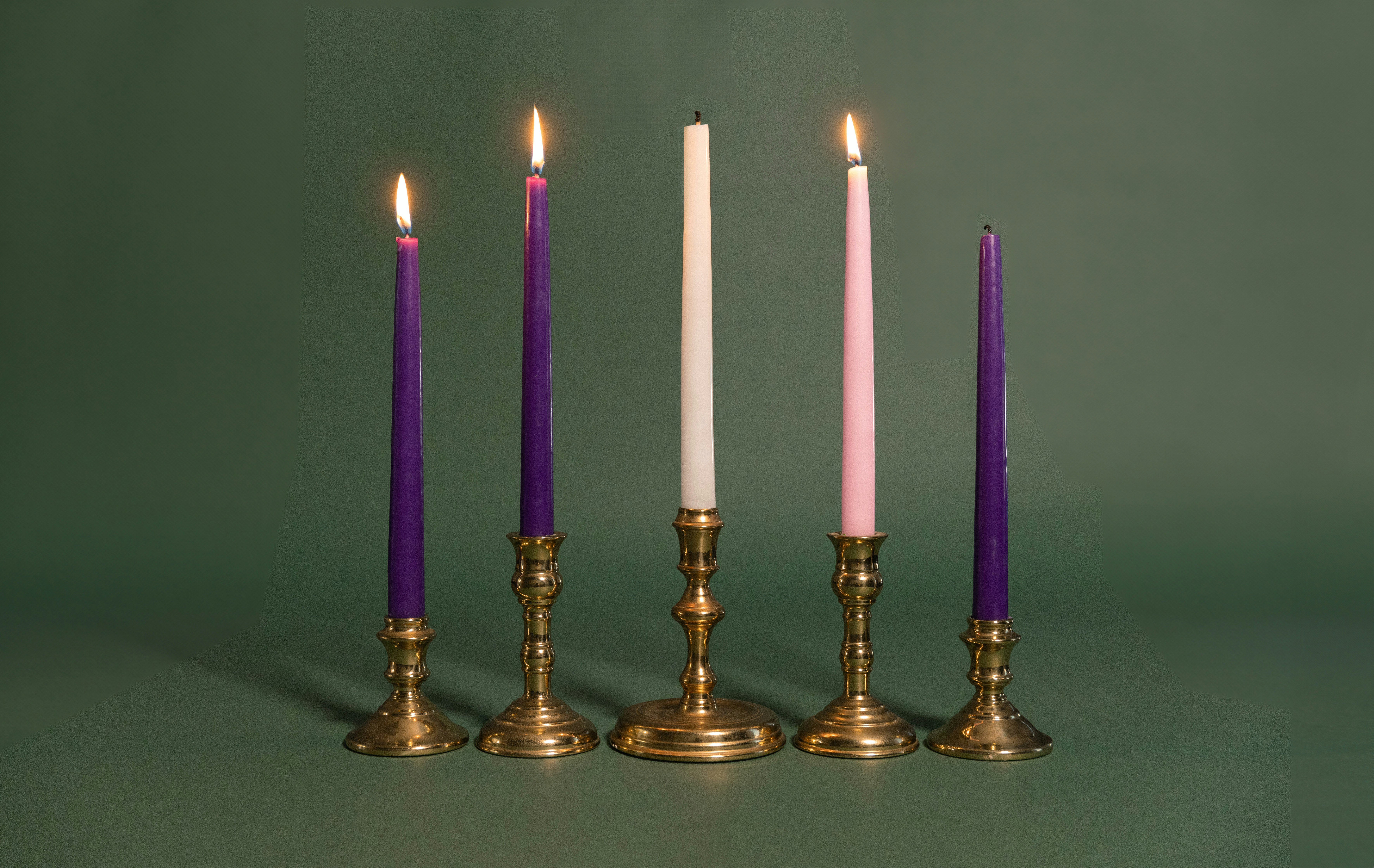 A group of three candles sitting next to each other