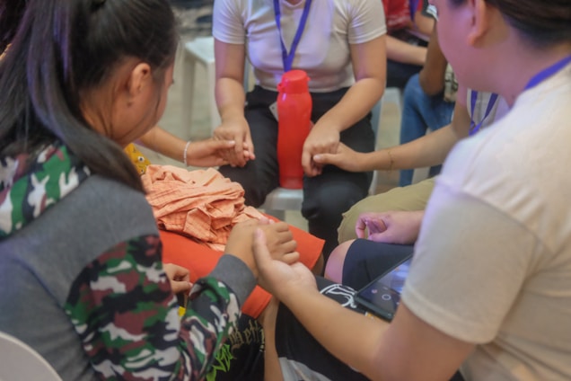 A group of people sitting around each other
