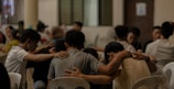 A group of people sitting around each other