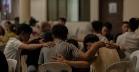 A group of people sitting around each other