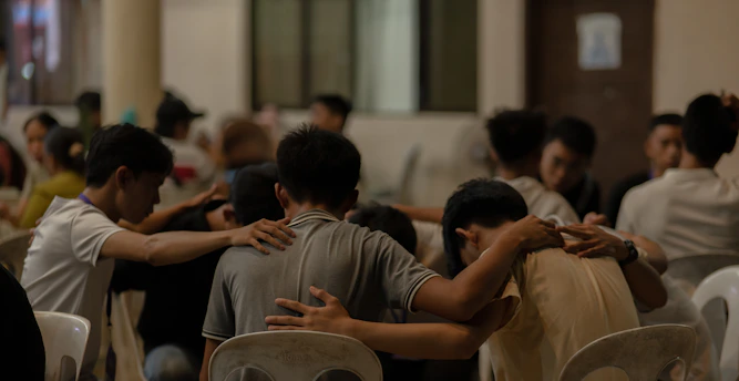 A group of people sitting around each other