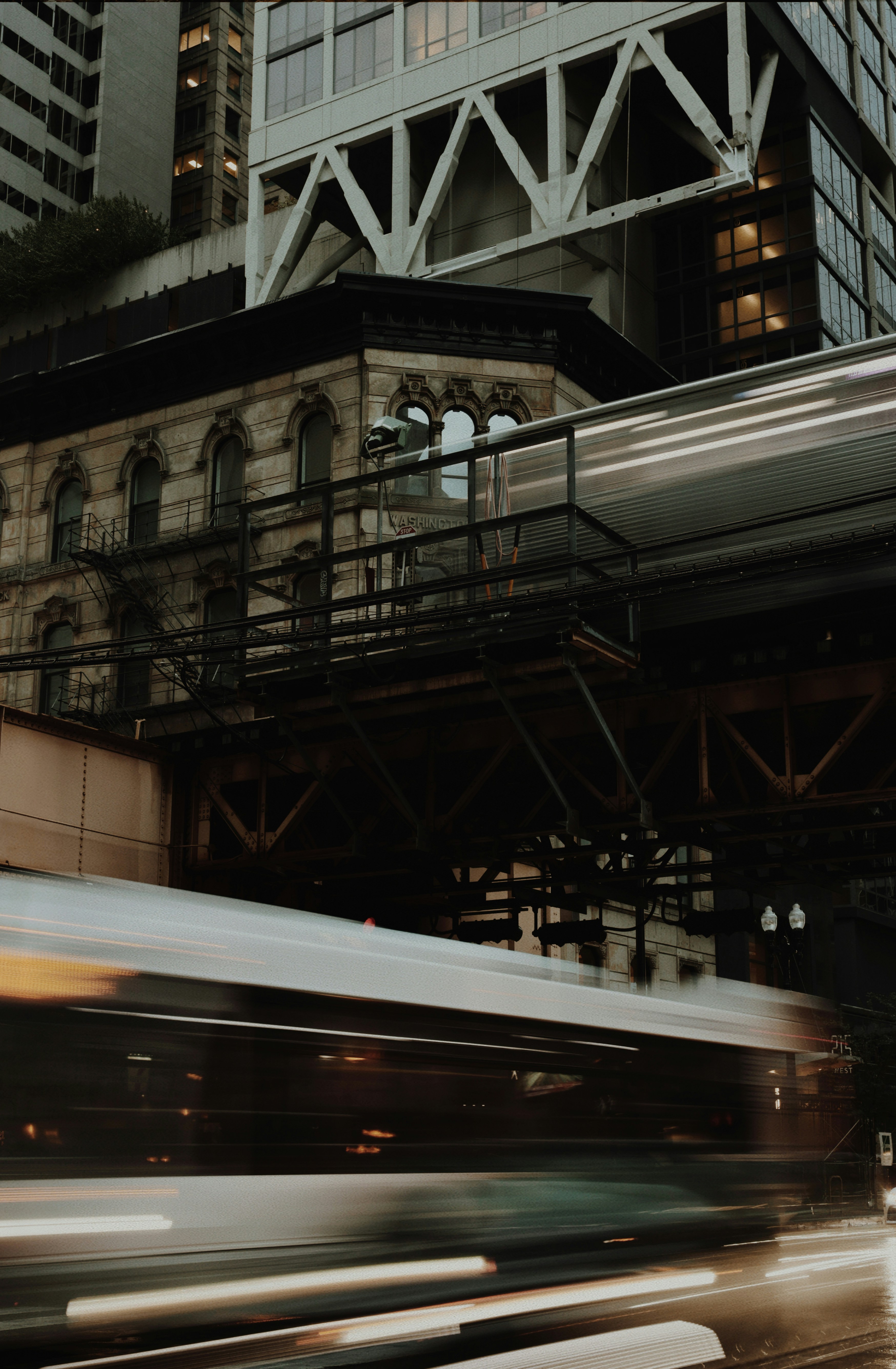 A train traveling past a tall building in the city