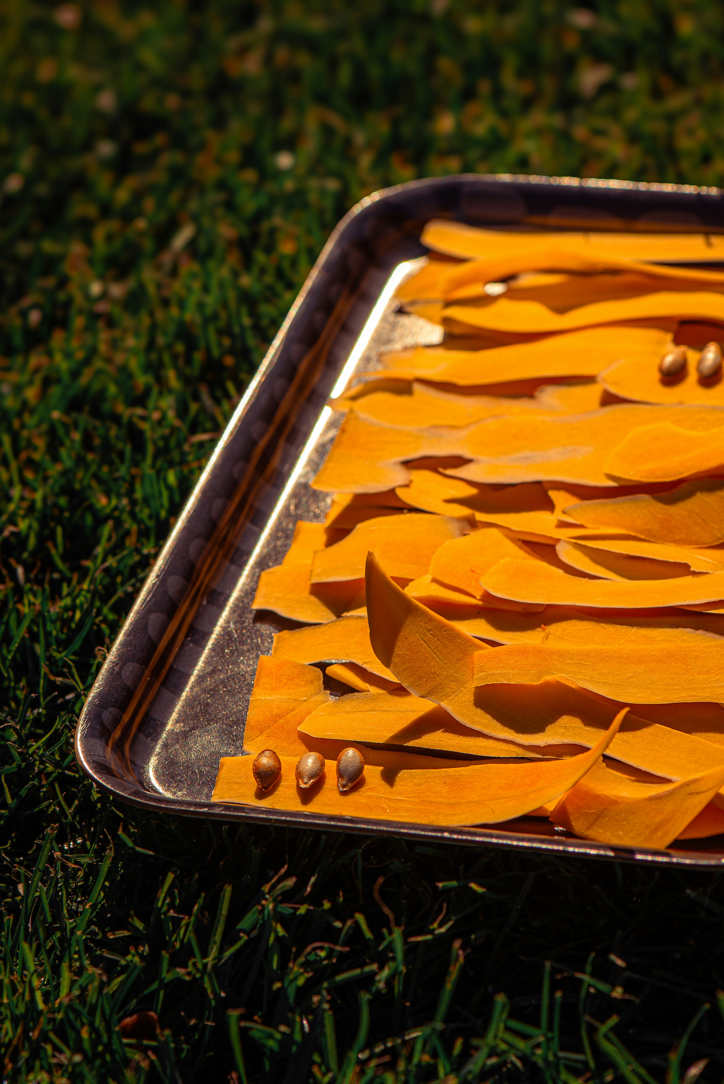 A metal tray with slices of pumpkin on it