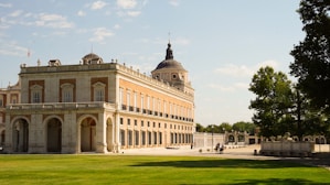 A large building sitting on top of a lush green field