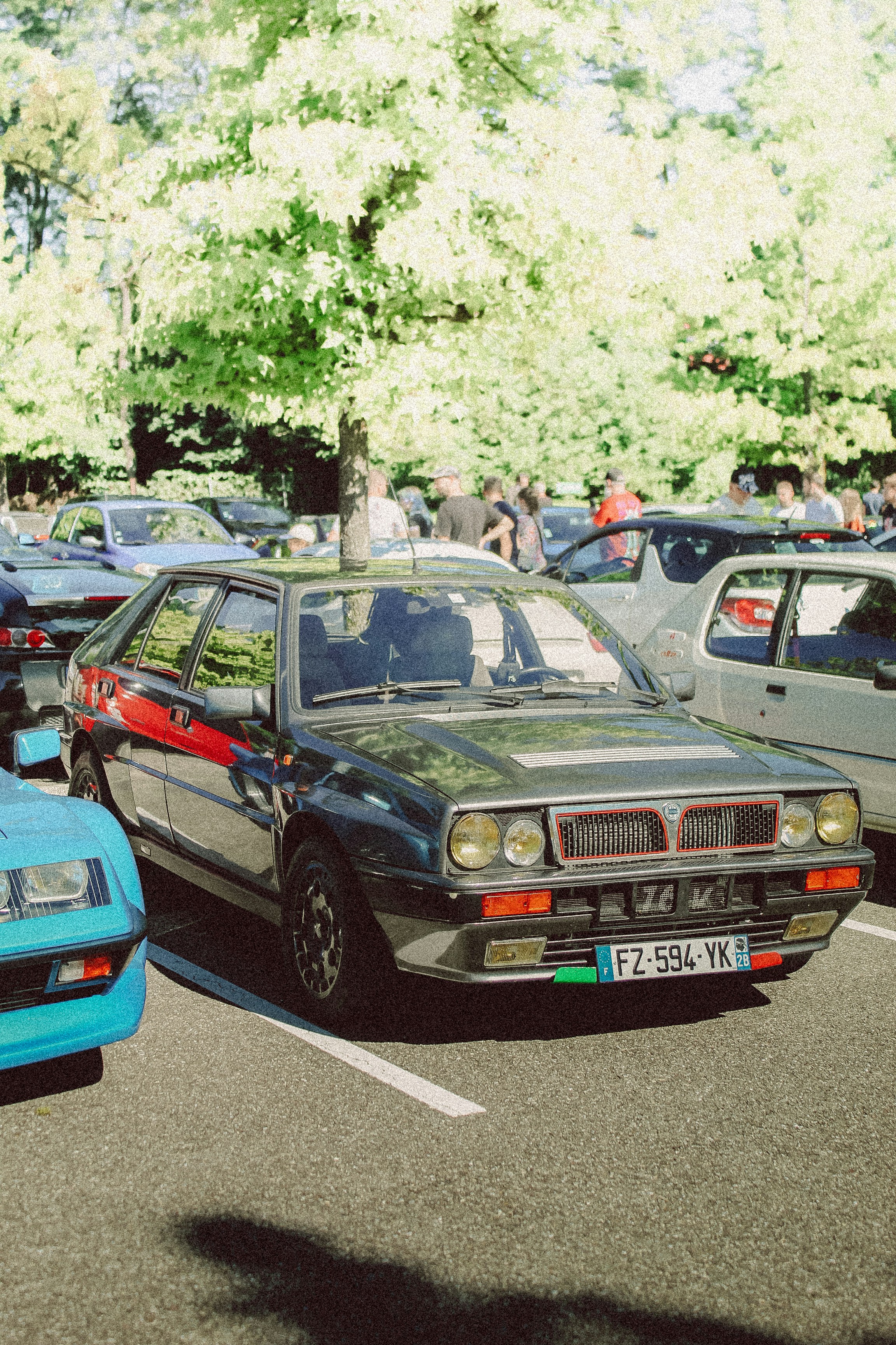 A group of cars parked next to each other in a parking lot