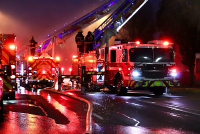A group of fire trucks driving down a street