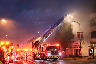 A group of fire trucks driving down a street