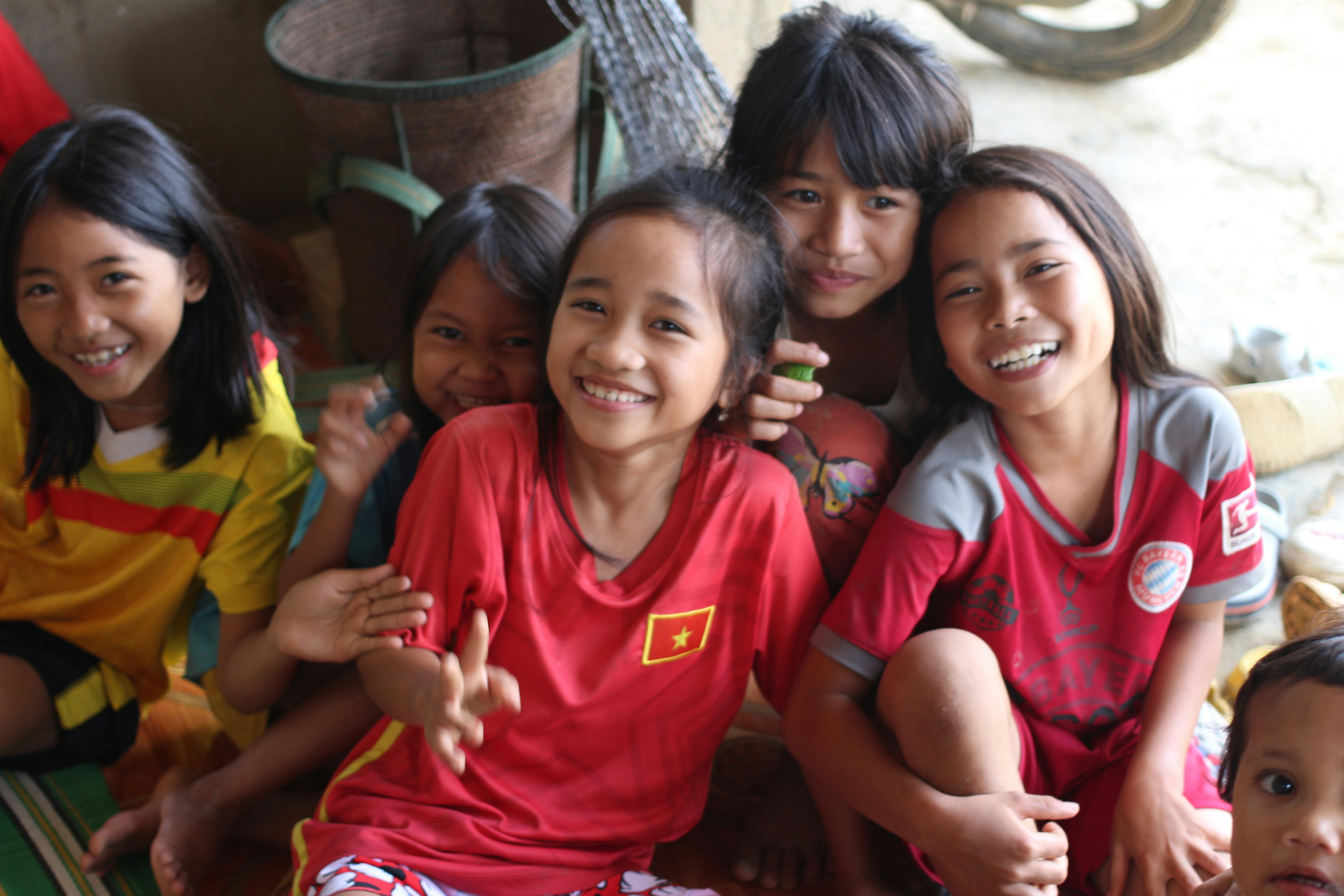 A group of young girls sitting next to each other