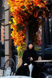 A woman sitting at a table with an umbrella