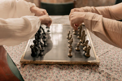 Two people playing a game of chess on a table
