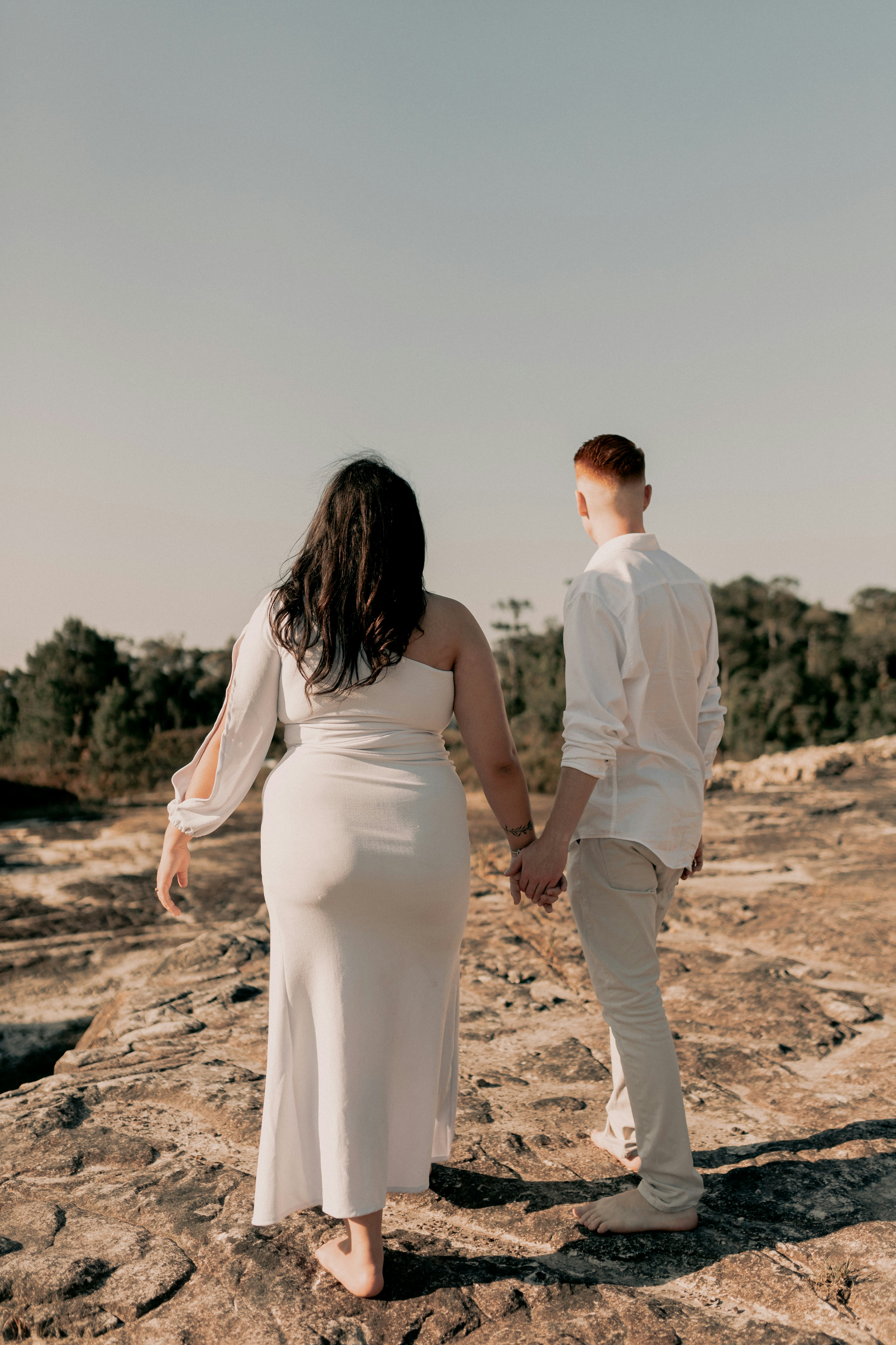 Pregnant couple holding hands and walking together