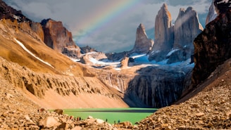 A rainbow in the sky over a mountain range