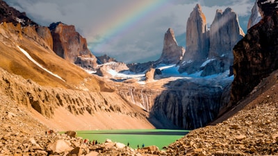 A rainbow in the sky over a mountain range