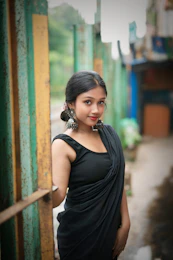 A woman in a black dress standing in a doorway