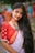 A woman with long hair wearing a red and white sari