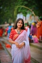 A woman in a red and white sari