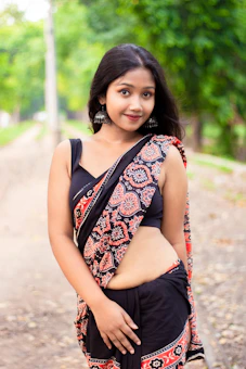 A woman in a sari posing for a picture