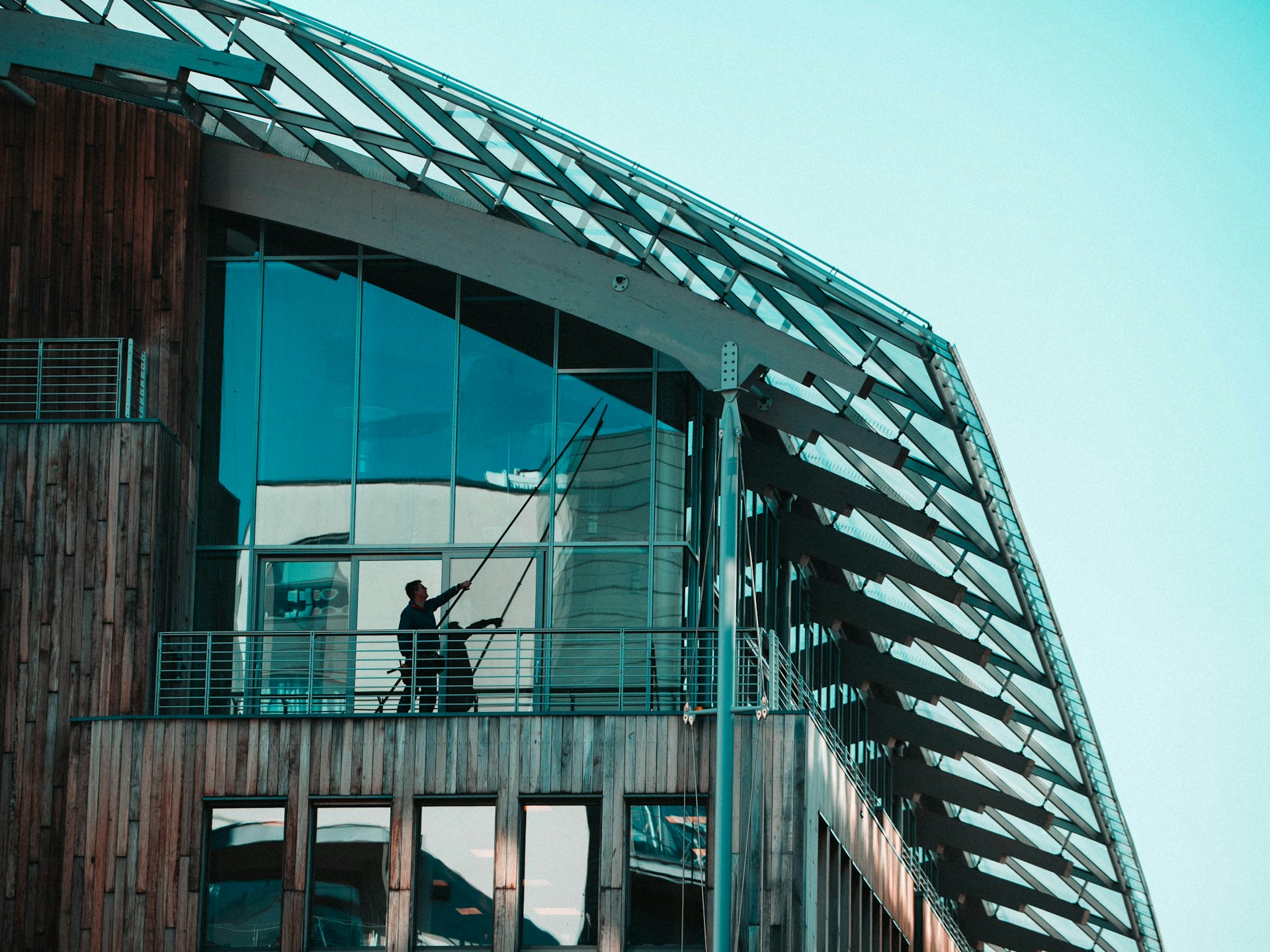 A man standing on a balcony of a building