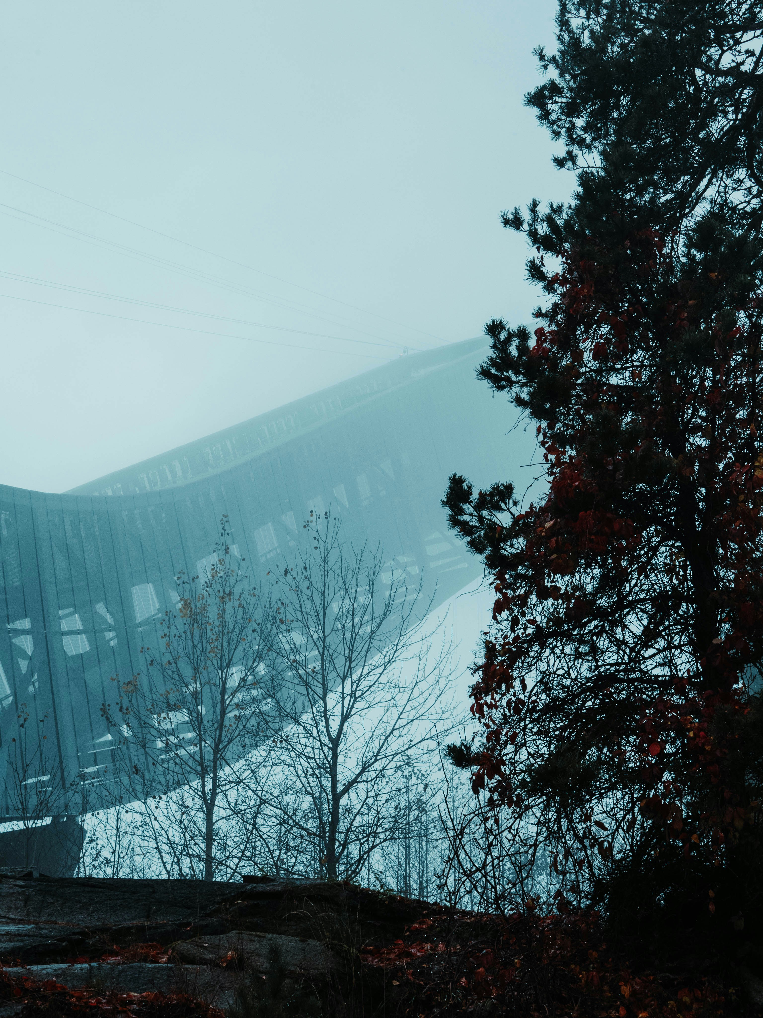 A train traveling over a bridge on a foggy day