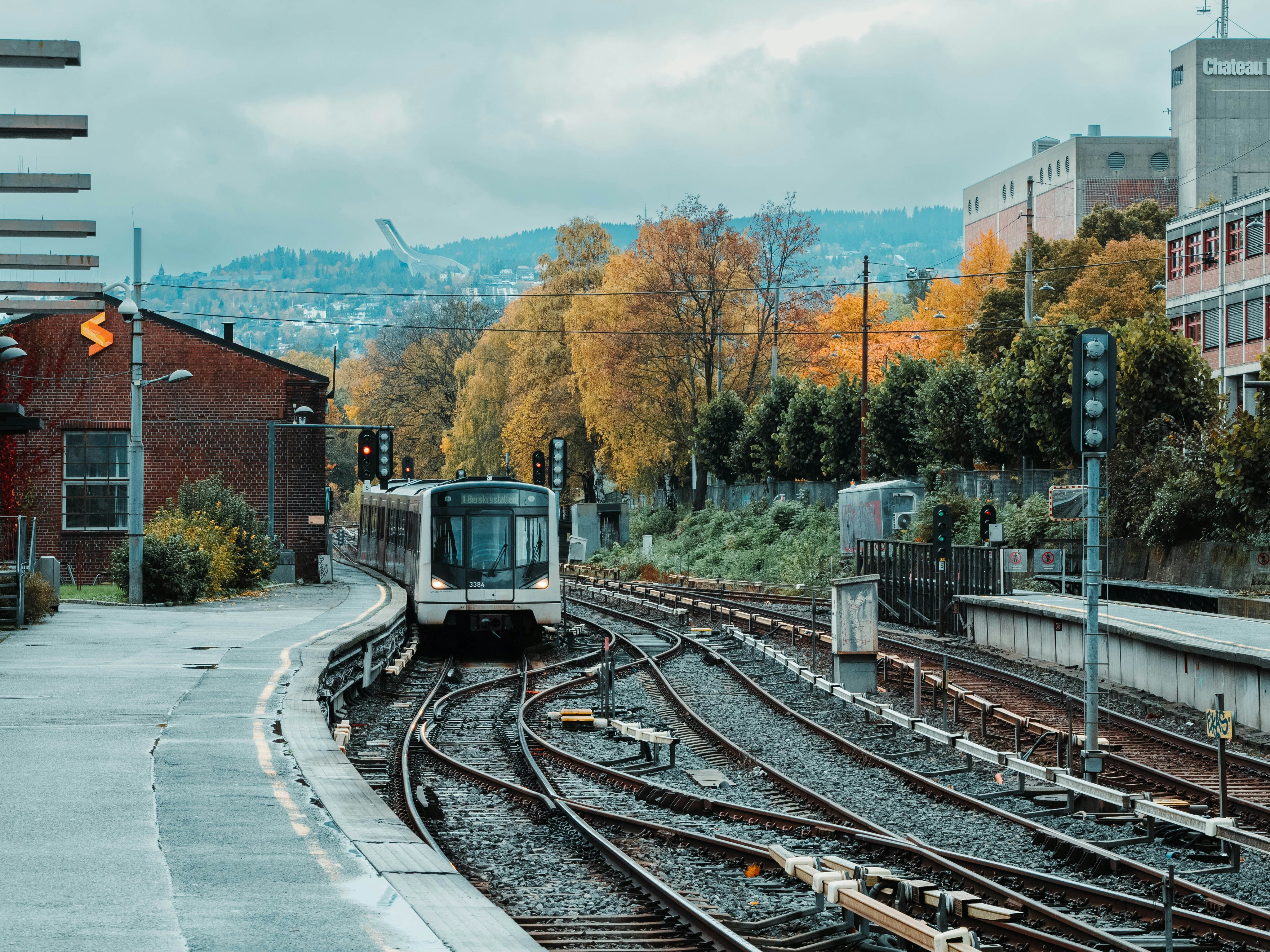 A train traveling down train tracks next to a train station