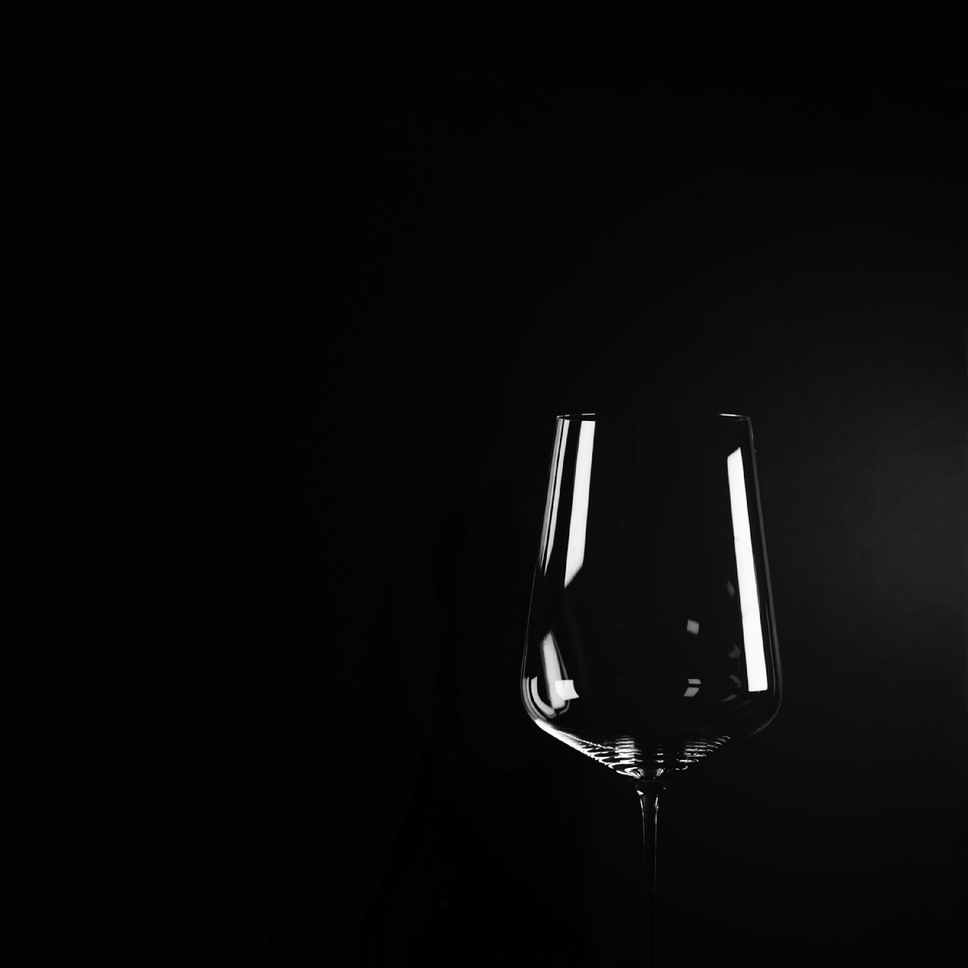 A couple of wine glasses sitting next to each other