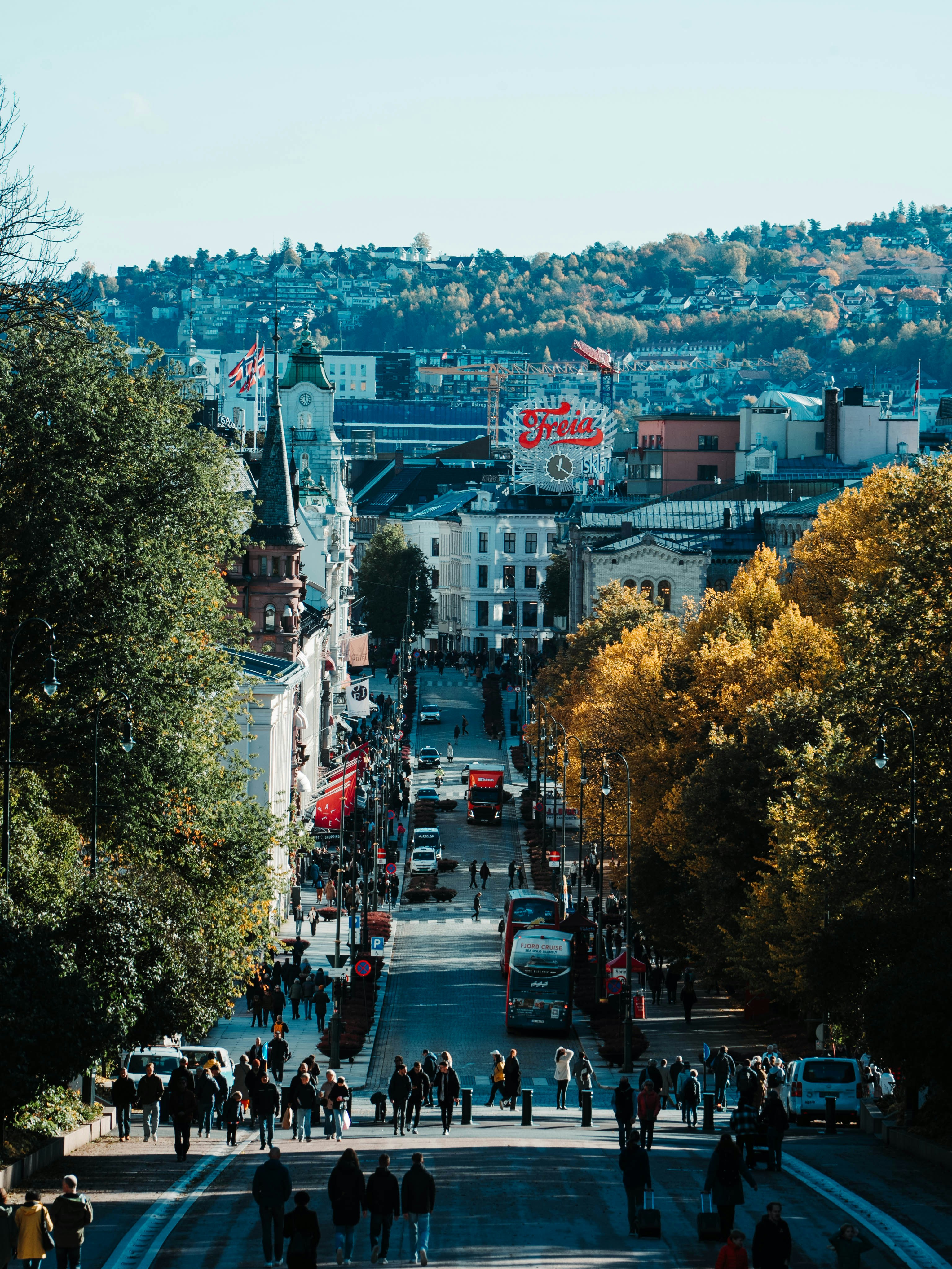 A city street with a lot of people walking down it