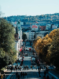 A city street with a lot of people walking down it