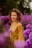 A woman standing in a field of purple flowers