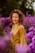 A woman standing in a field of purple flowers
