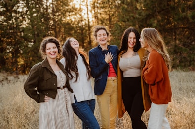 A group of women standing next to each other in a field