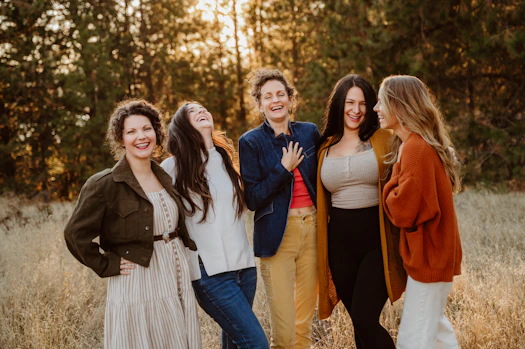 A group of women standing next to each other in a field