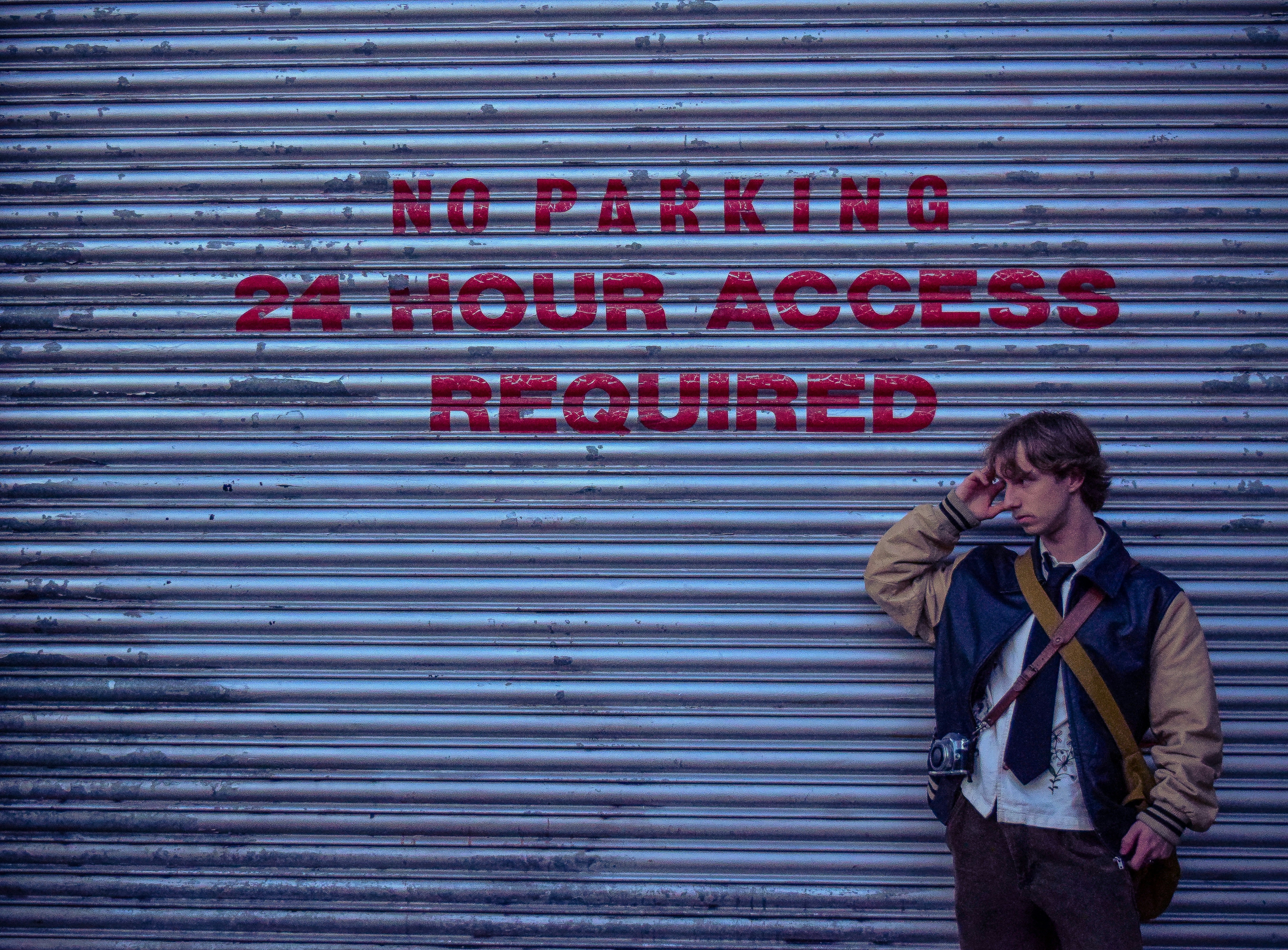 A man standing in front of a garage door