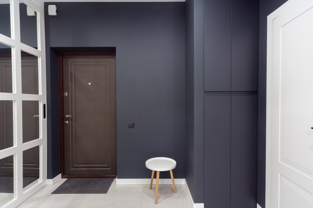 A room with a chair and a door,
