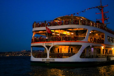 A large white boat floating on top of a body of water