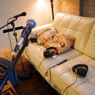 A couch with headphones and a microphone in a living room