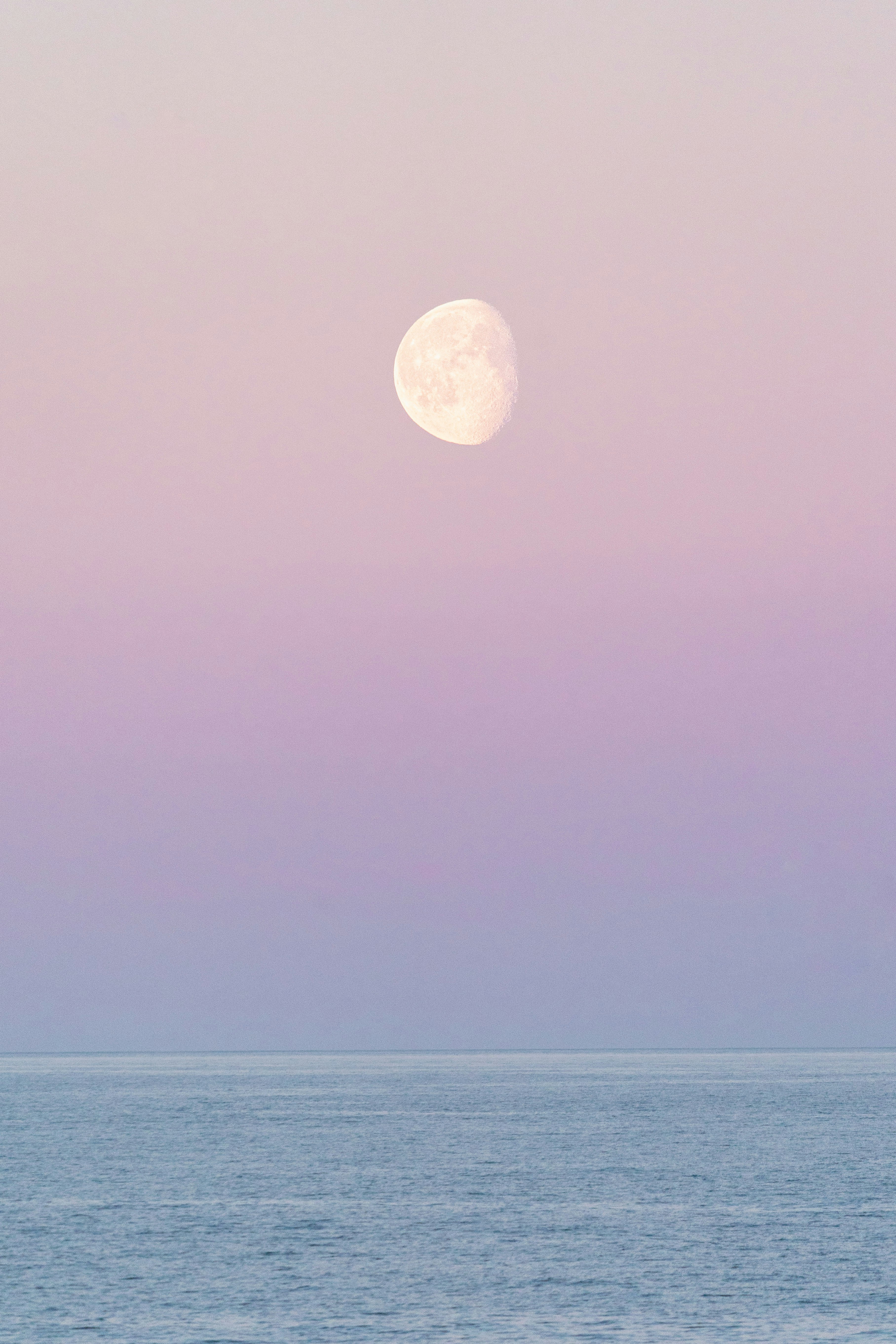 A full moon is seen over the ocean