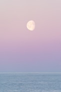 A full moon is seen over the ocean