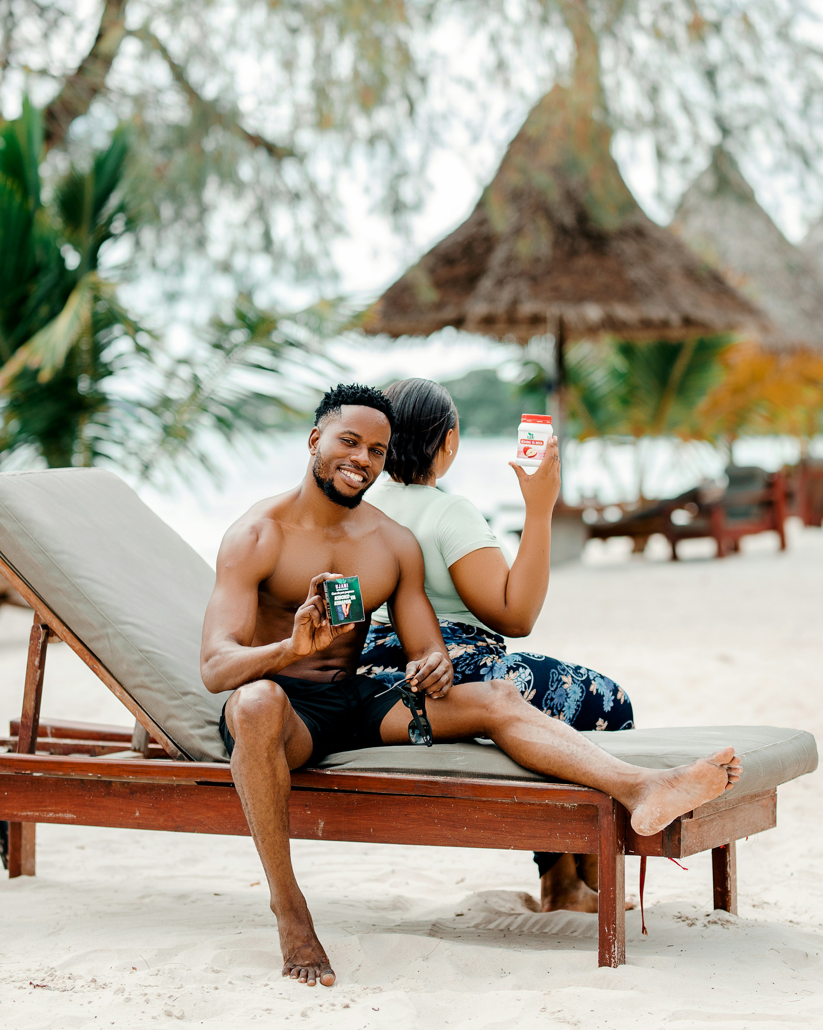 A man and a woman sitting on a beach