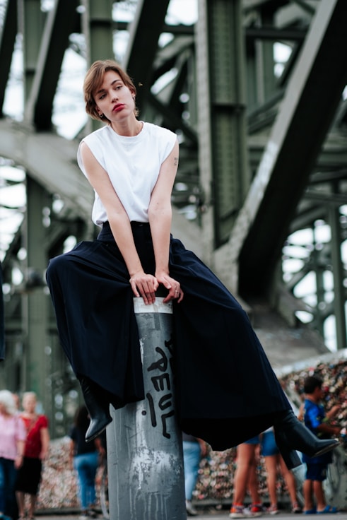 A woman standing on top of a fire hydrant