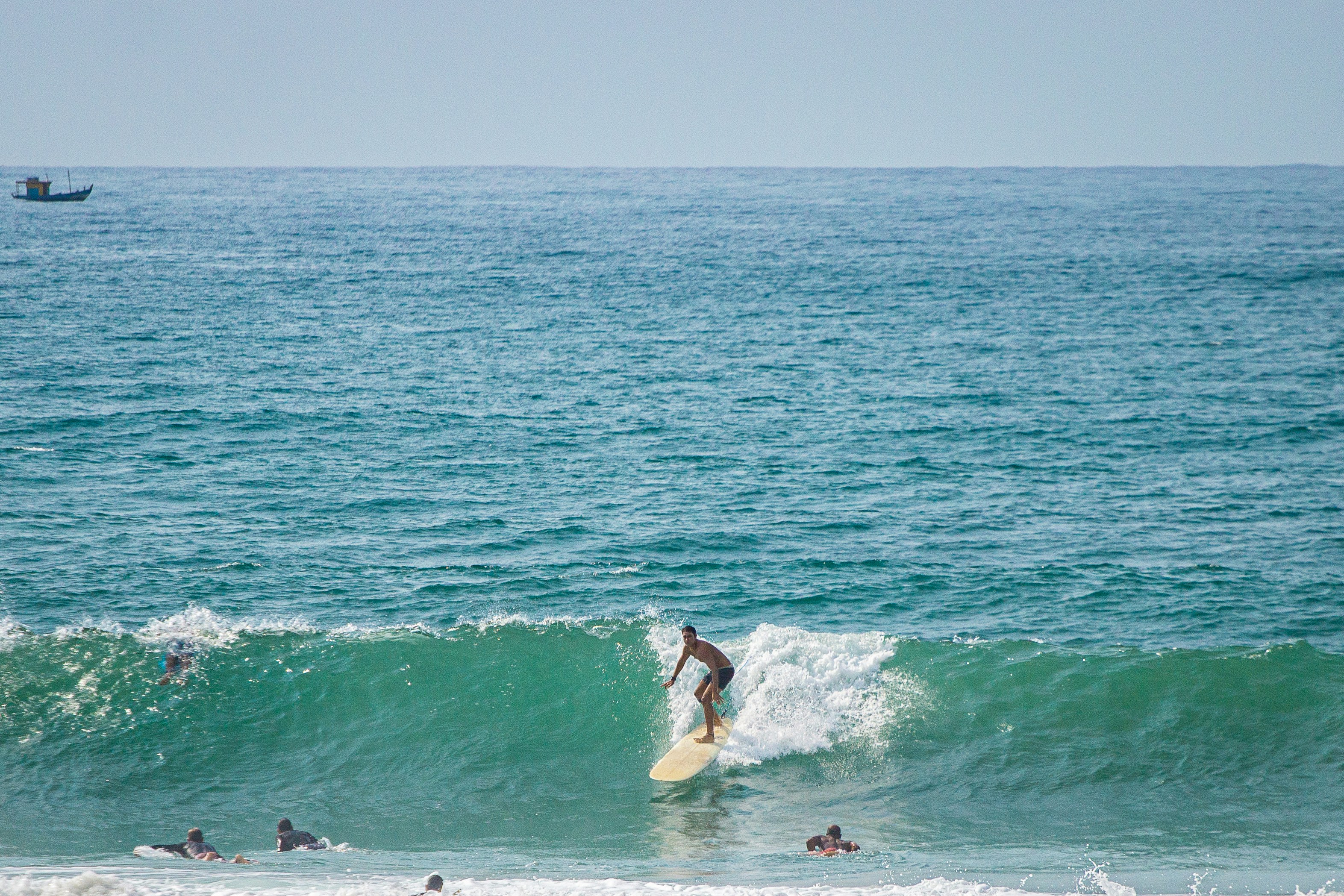 A man riding a wave on top of a surfboard