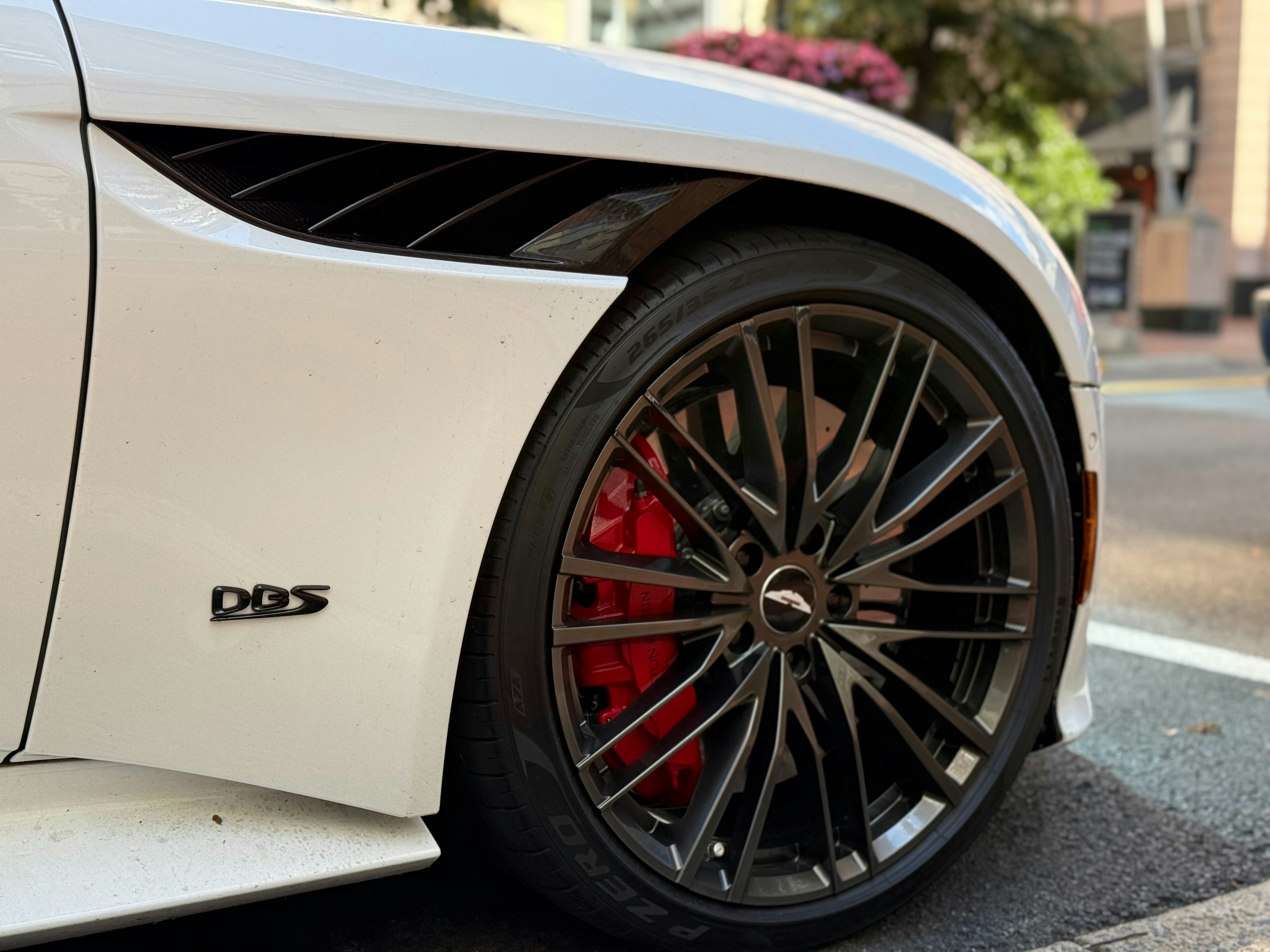 A white sports car parked on the side of the road