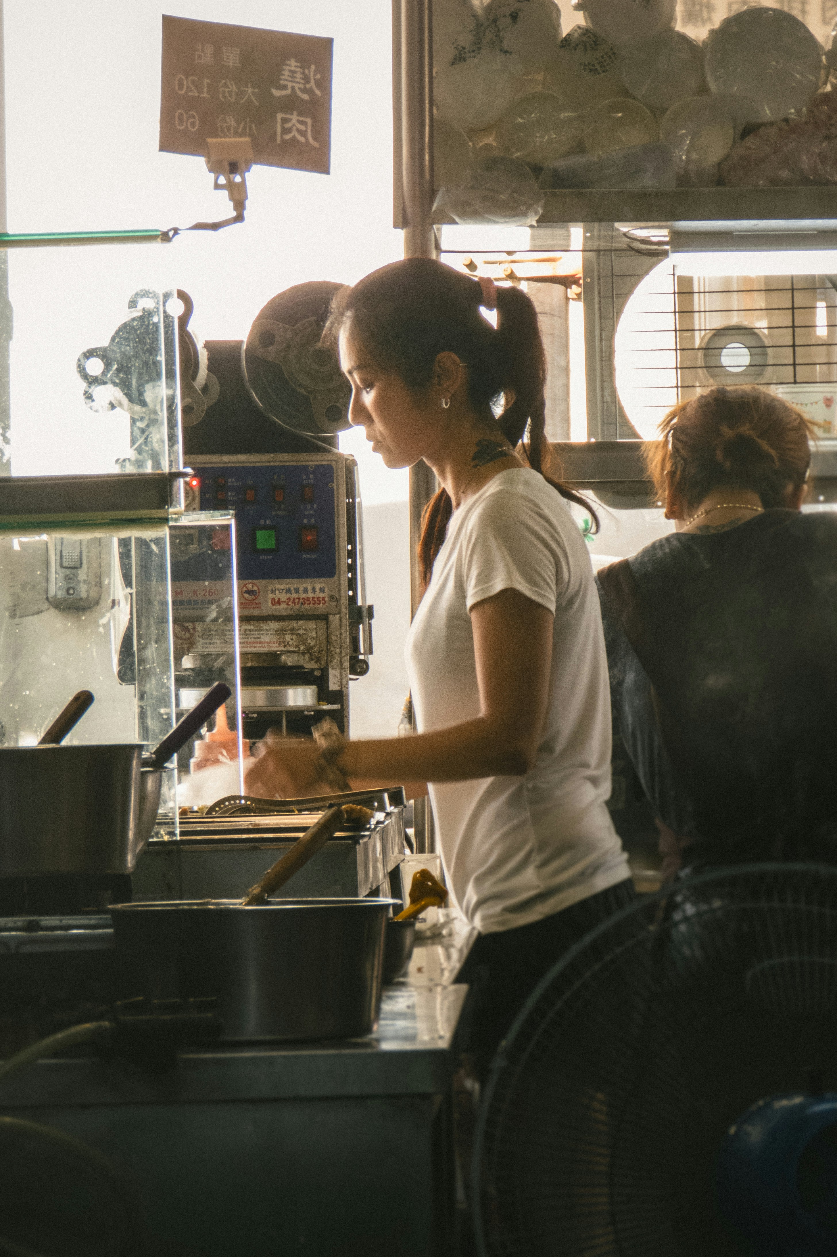 A woman standing at a counter in a restaurant