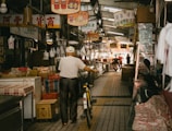 A man riding a bike down a wooden floor