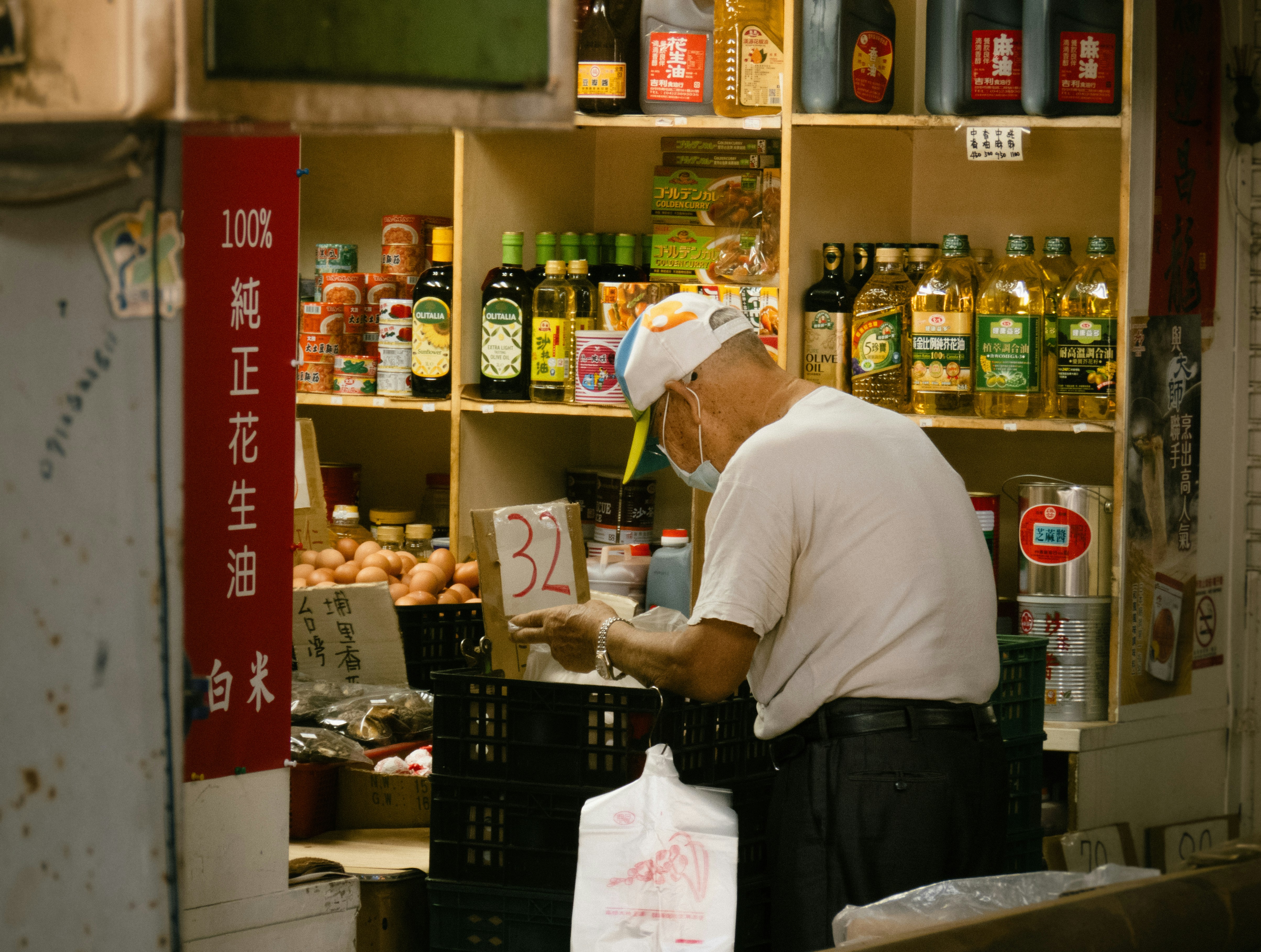 A man standing in front of a store filled with food