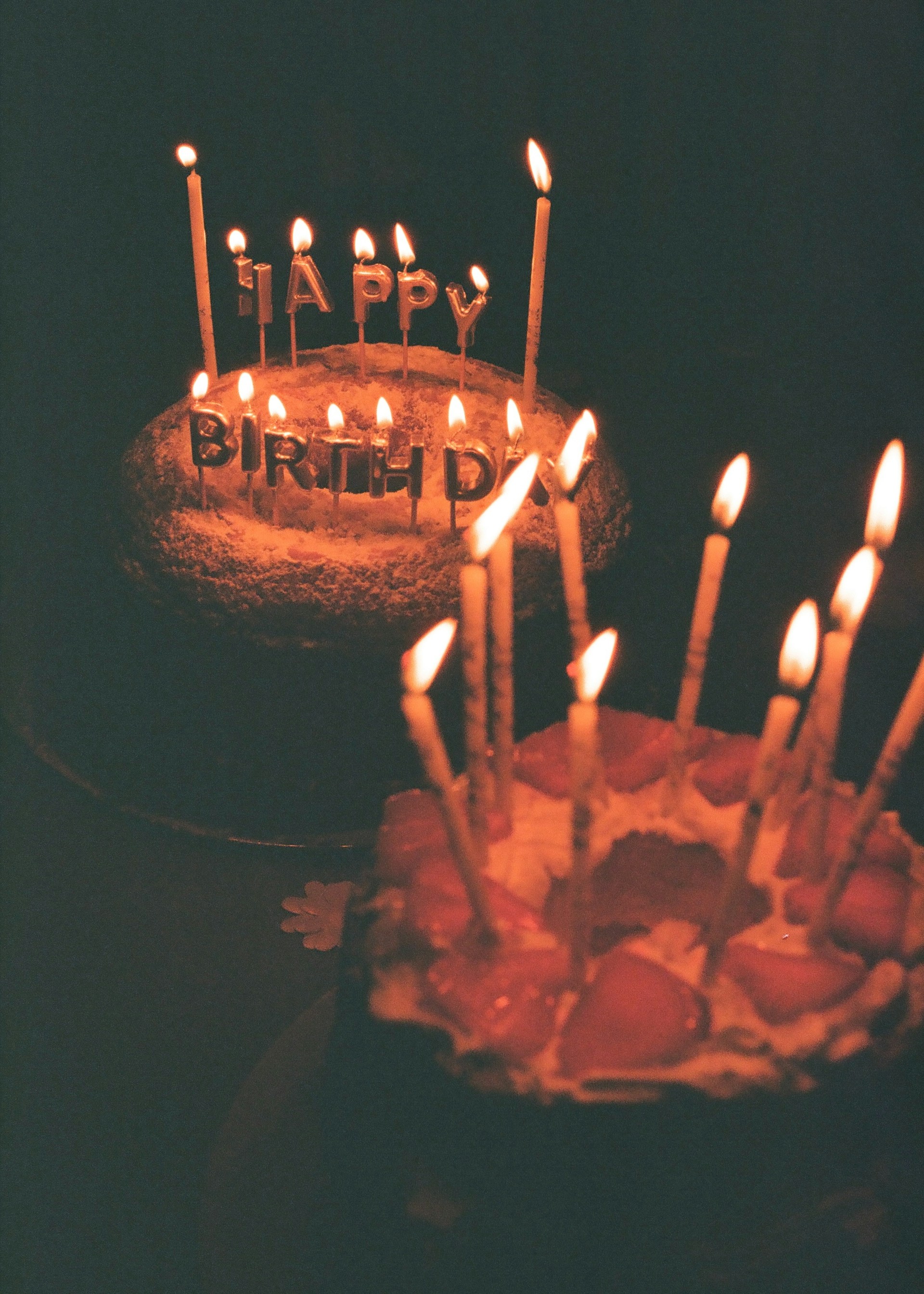 A birthday cake with lit candles sitting on a table